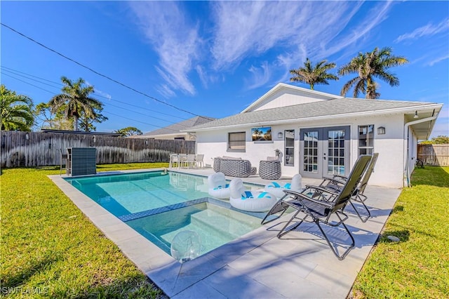 view of pool featuring a fenced in pool, french doors, a patio, a lawn, and a fenced backyard