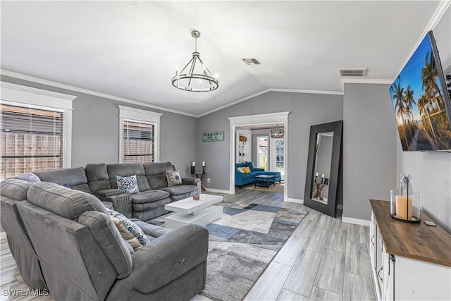 living area with a notable chandelier, visible vents, and crown molding