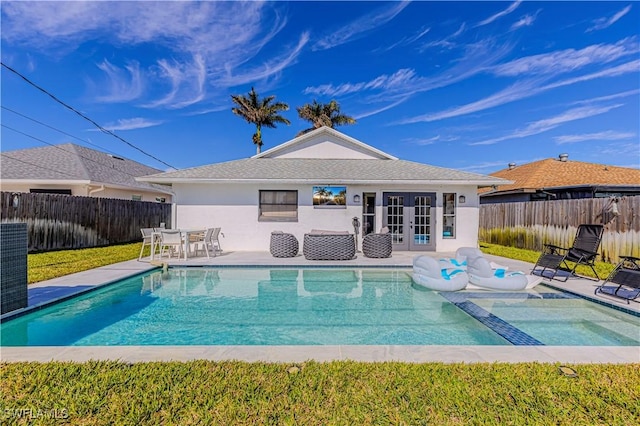 view of pool with french doors, a patio area, a fenced backyard, and a fenced in pool