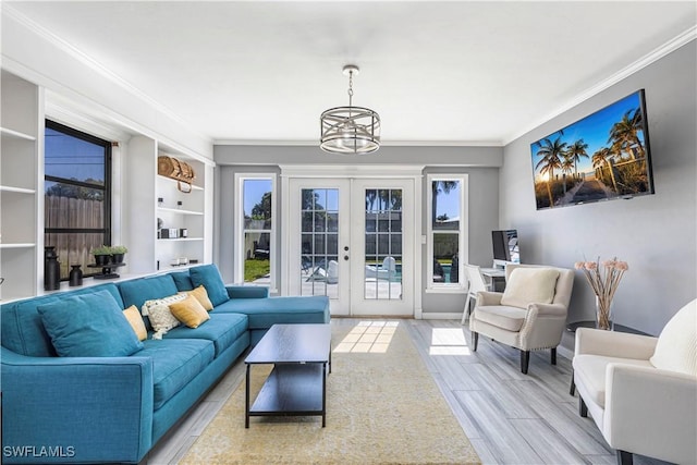 living area with light wood finished floors, french doors, ornamental molding, and baseboards