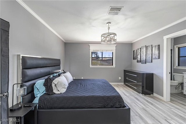 bedroom featuring baseboards, crown molding, visible vents, and wood finished floors