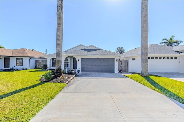 single story home featuring a garage, concrete driveway, a front lawn, and fence