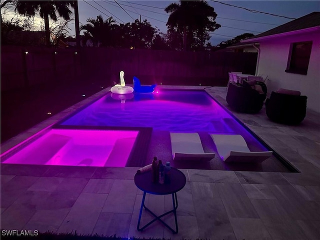 pool at dusk featuring a fenced in pool, a patio area, and a fenced backyard