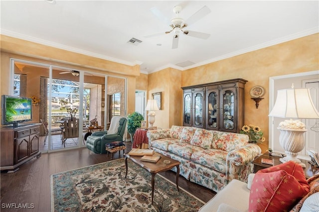 living room with dark wood-type flooring, ceiling fan, and crown molding