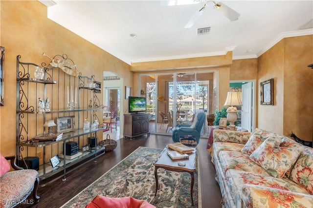 living room featuring ornamental molding, dark wood-type flooring, and ceiling fan