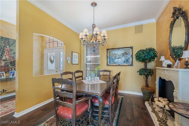 dining area with ornamental molding, an inviting chandelier, and dark hardwood / wood-style flooring