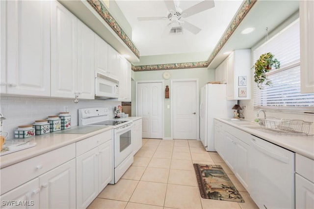 kitchen with white cabinetry, light tile patterned floors, ceiling fan, white appliances, and decorative backsplash