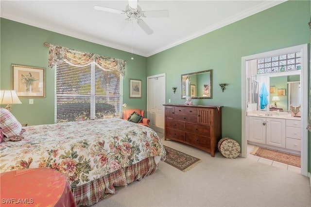 bedroom with ensuite bath, ornamental molding, carpet flooring, a closet, and ceiling fan