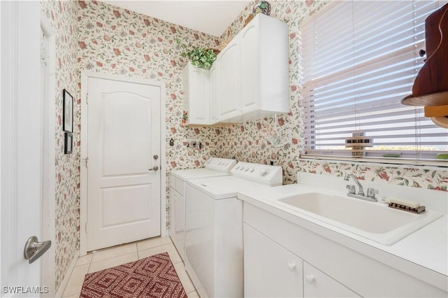 washroom featuring cabinets, separate washer and dryer, sink, and light tile patterned floors