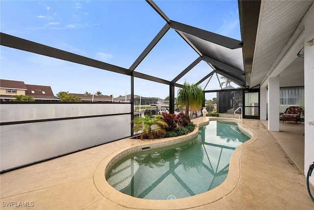 view of swimming pool featuring a patio and a lanai