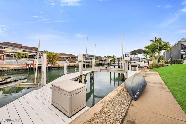 view of dock featuring a water view and a yard