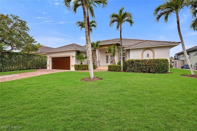 view of front facade with a garage and a front lawn