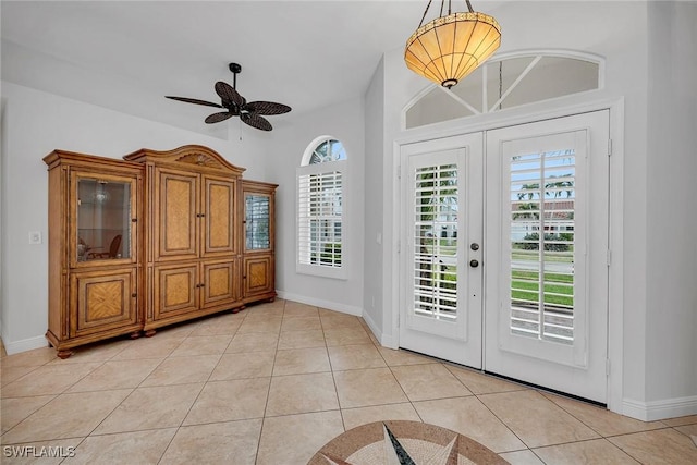 tiled foyer entrance with french doors and ceiling fan