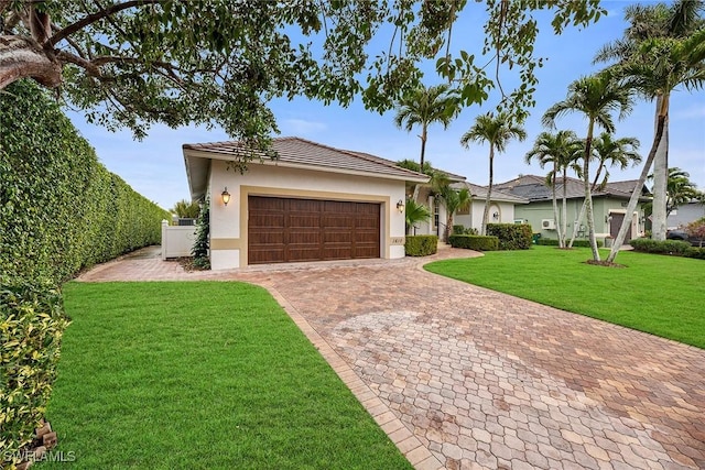 ranch-style home featuring a garage and a front yard