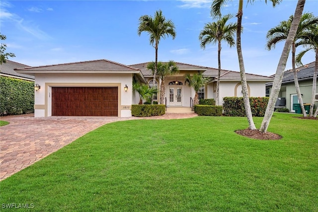 view of front of home featuring a garage and a front lawn