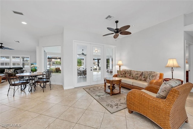 tiled living room with french doors and ceiling fan