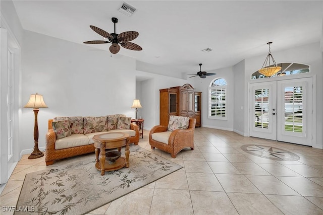 living room featuring light tile patterned floors, ceiling fan, and french doors