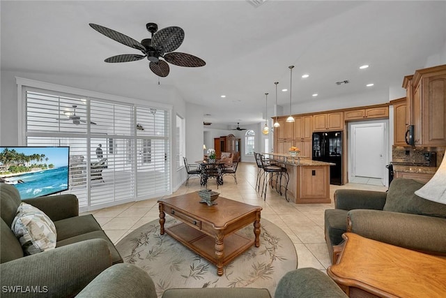 tiled living room with ceiling fan