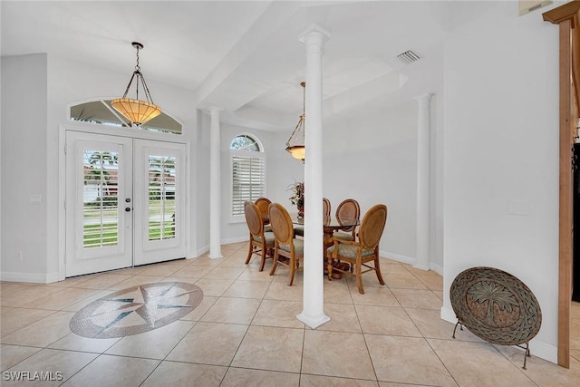 dining area with decorative columns, light tile patterned flooring, and french doors