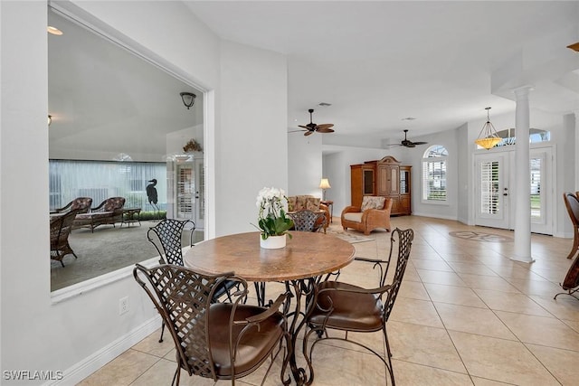 dining space featuring light tile patterned floors and ornate columns