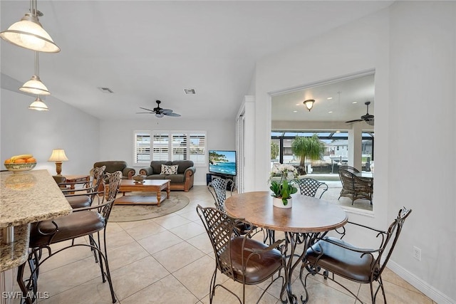 tiled dining area with ceiling fan