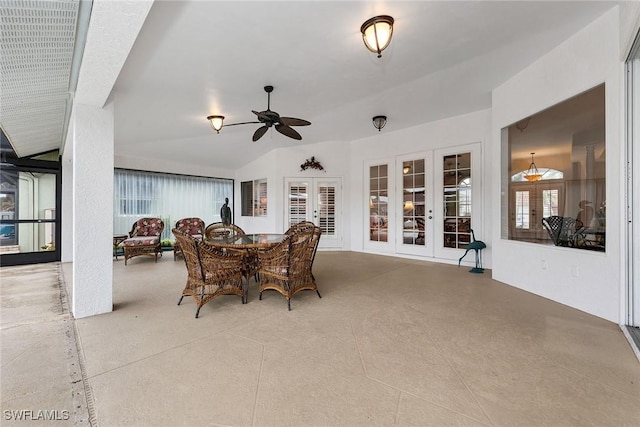 dining area with lofted ceiling, ceiling fan, and french doors