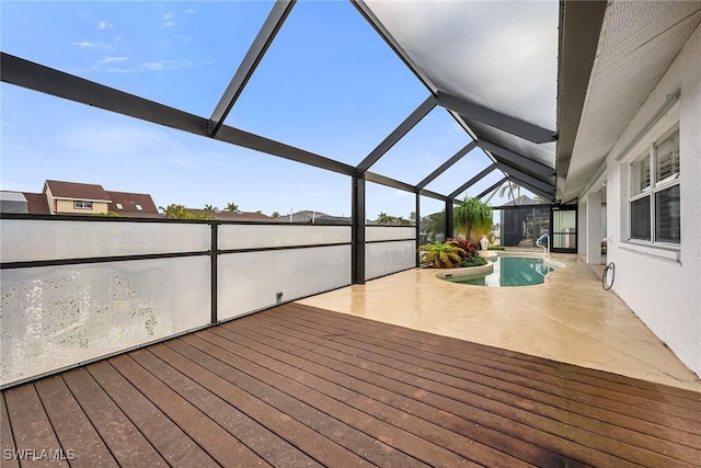 wooden deck with a patio, a fenced in pool, and glass enclosure