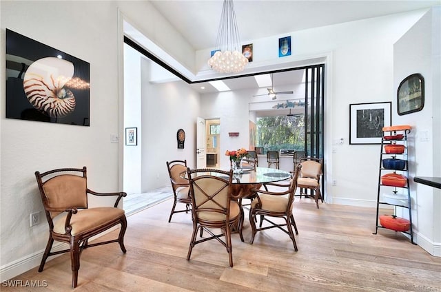 dining space featuring a chandelier and light hardwood / wood-style floors