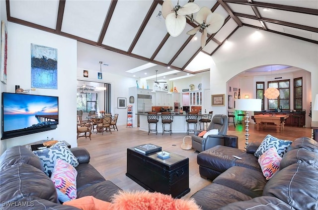 living room with pool table, high vaulted ceiling, light hardwood / wood-style flooring, ceiling fan, and beam ceiling