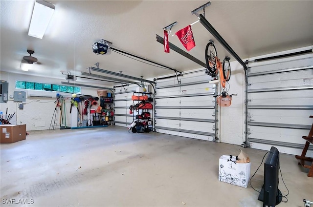 garage featuring a garage door opener and electric panel