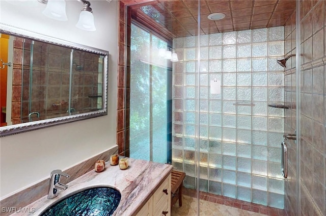 bathroom featuring walk in shower and vanity