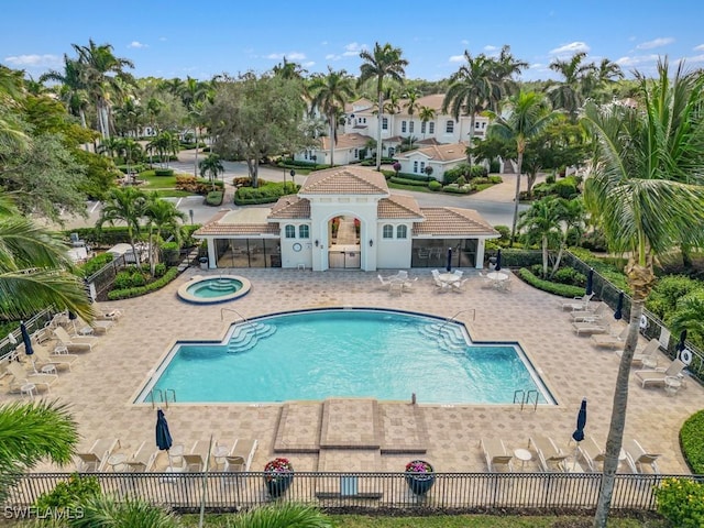 15540 Monterosso Ln Unit 202, Naples, FL 34110 - community pool featuring a hot tub, fence, and a patio