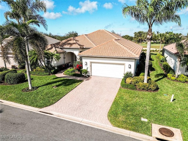 mediterranean / spanish-style home with a garage and a front yard