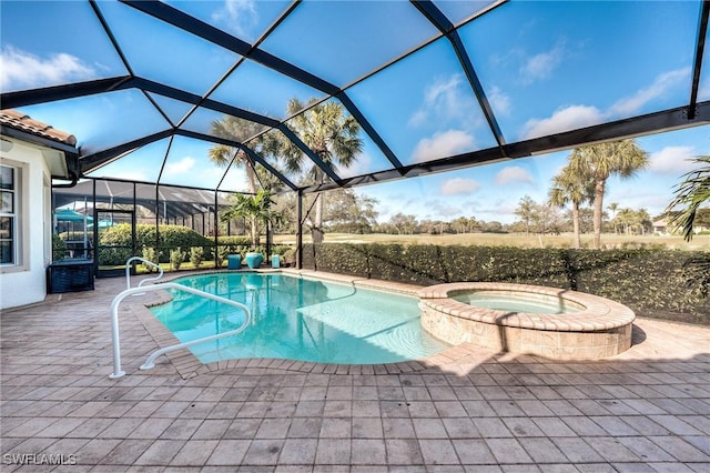 view of pool with an in ground hot tub, a lanai, and a patio