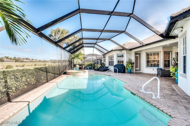 view of pool with an in ground hot tub, a lanai, and a patio area