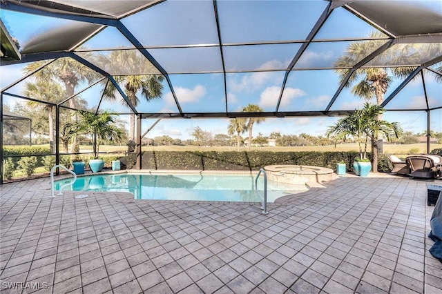 view of pool with a lanai, a patio area, and an in ground hot tub