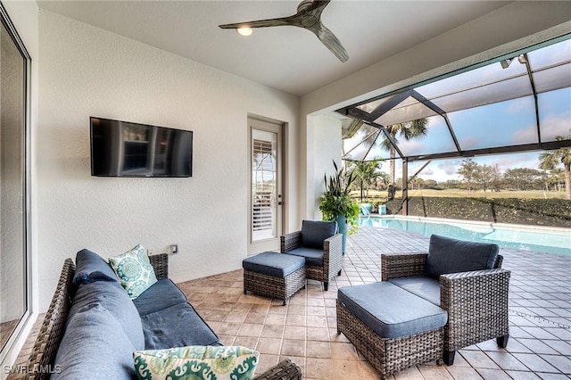 view of patio featuring an outdoor hangout area, ceiling fan, and glass enclosure