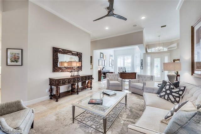 living room featuring crown molding and ceiling fan with notable chandelier