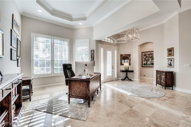 office featuring a notable chandelier, ornamental molding, a raised ceiling, and a high ceiling