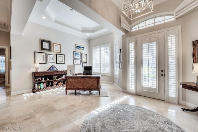 foyer featuring a tray ceiling, light tile patterned floors, crown molding, and a chandelier