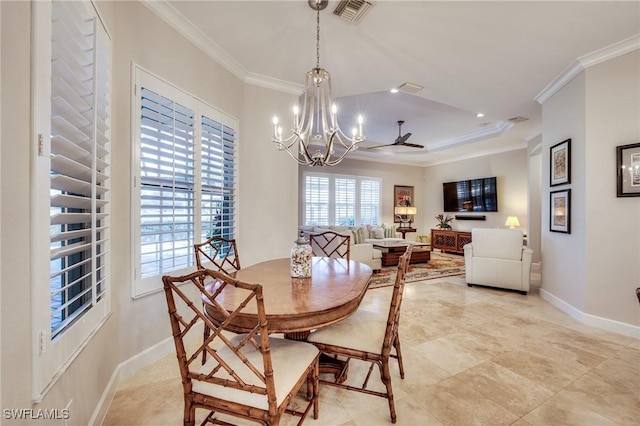 dining space with crown molding, a chandelier, and a tray ceiling