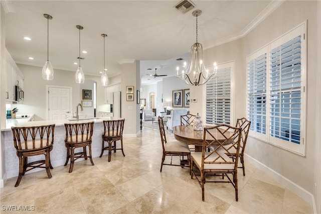 dining area featuring sink, crown molding, and ceiling fan with notable chandelier