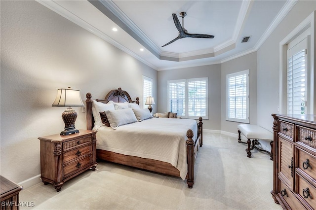 carpeted bedroom with a raised ceiling, ornamental molding, and ceiling fan