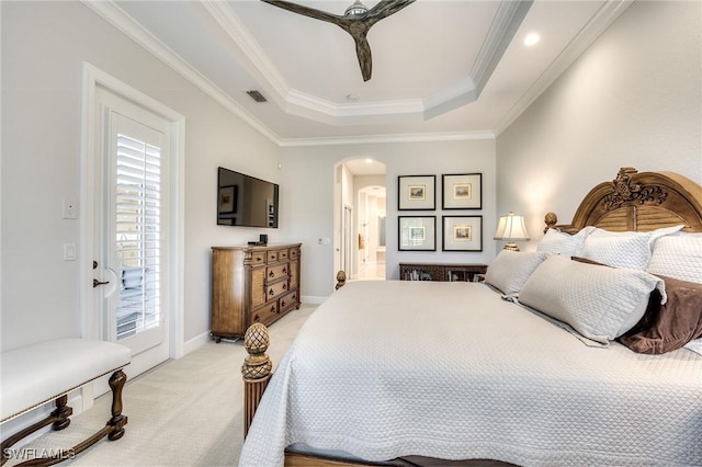 carpeted bedroom with ceiling fan, connected bathroom, ornamental molding, access to outside, and a raised ceiling