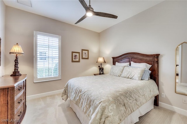 bedroom with lofted ceiling, light carpet, and ceiling fan