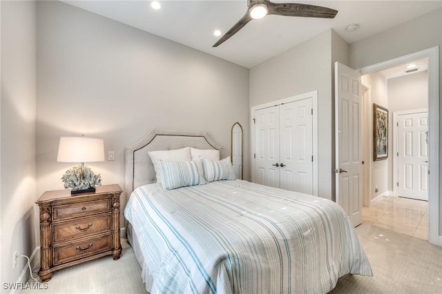 carpeted bedroom with ceiling fan and a closet