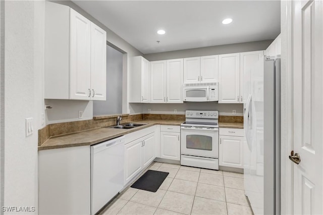 kitchen featuring white cabinetry, white appliances, sink, and light tile patterned floors