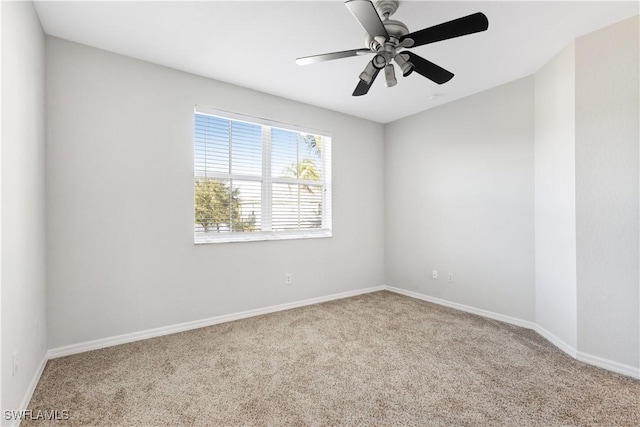 carpeted spare room with ceiling fan