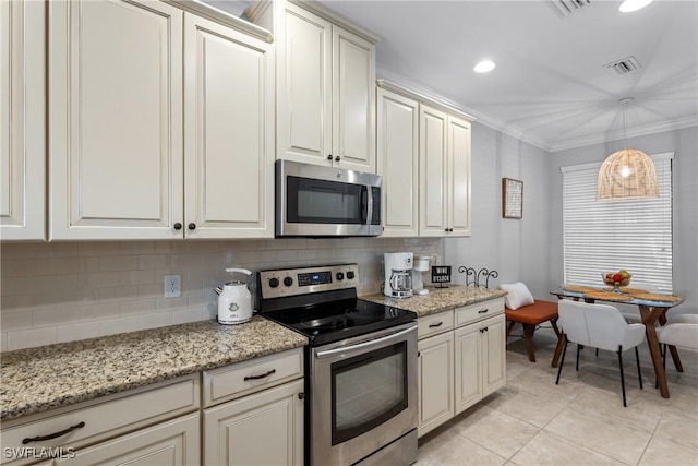 kitchen with appliances with stainless steel finishes, tasteful backsplash, light tile patterned flooring, ornamental molding, and hanging light fixtures