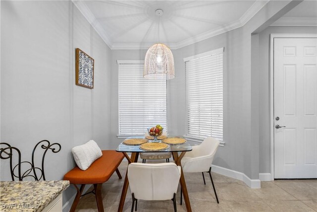 dining room with baseboards and crown molding